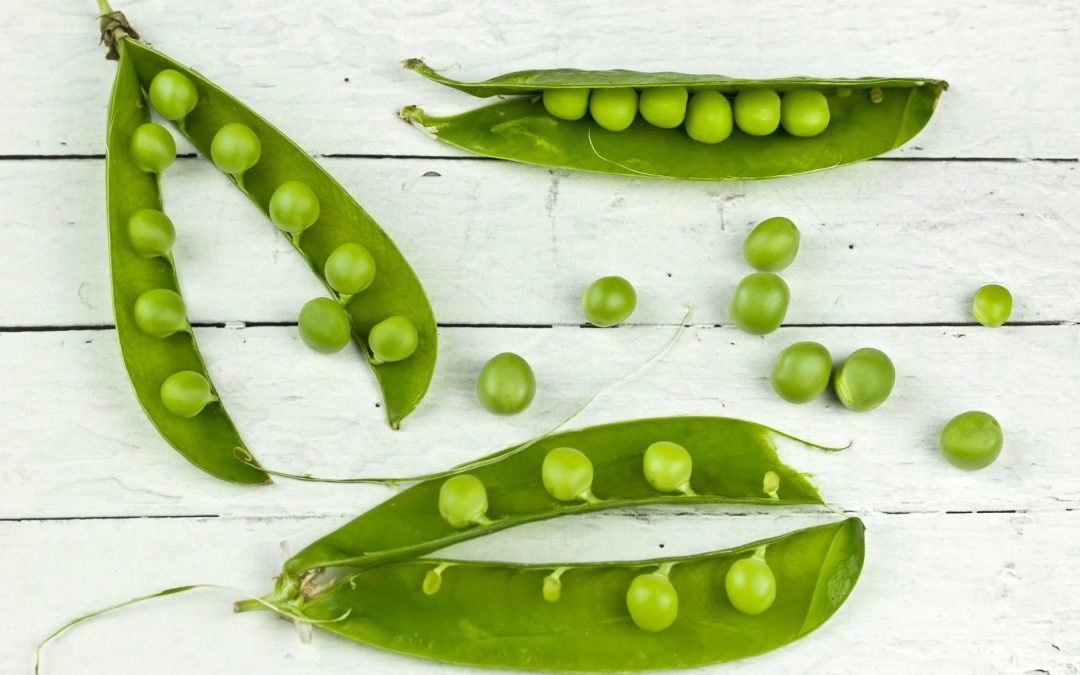 green peas on a white table