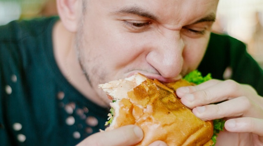 man eating a hamburger